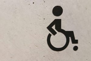 Wheelchair accessibility symbol on a textured surface